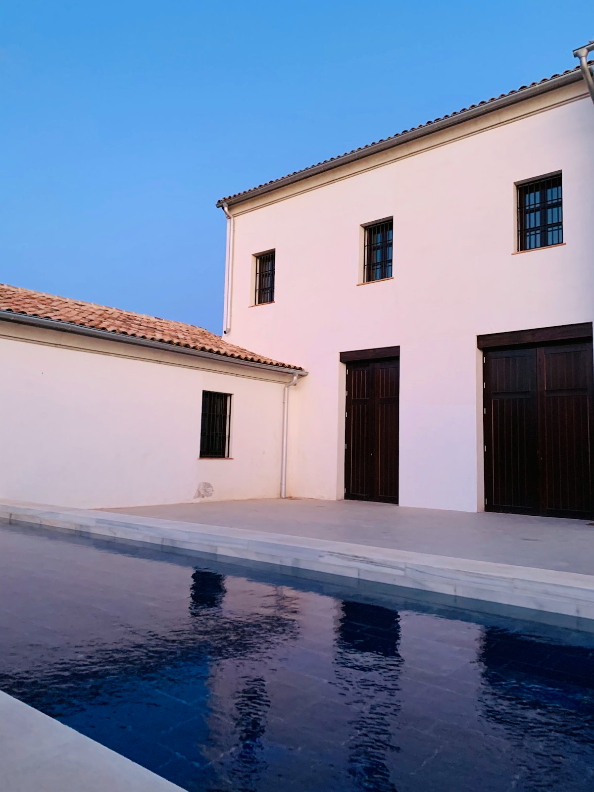 White stone house set into a Mediterranean landscape