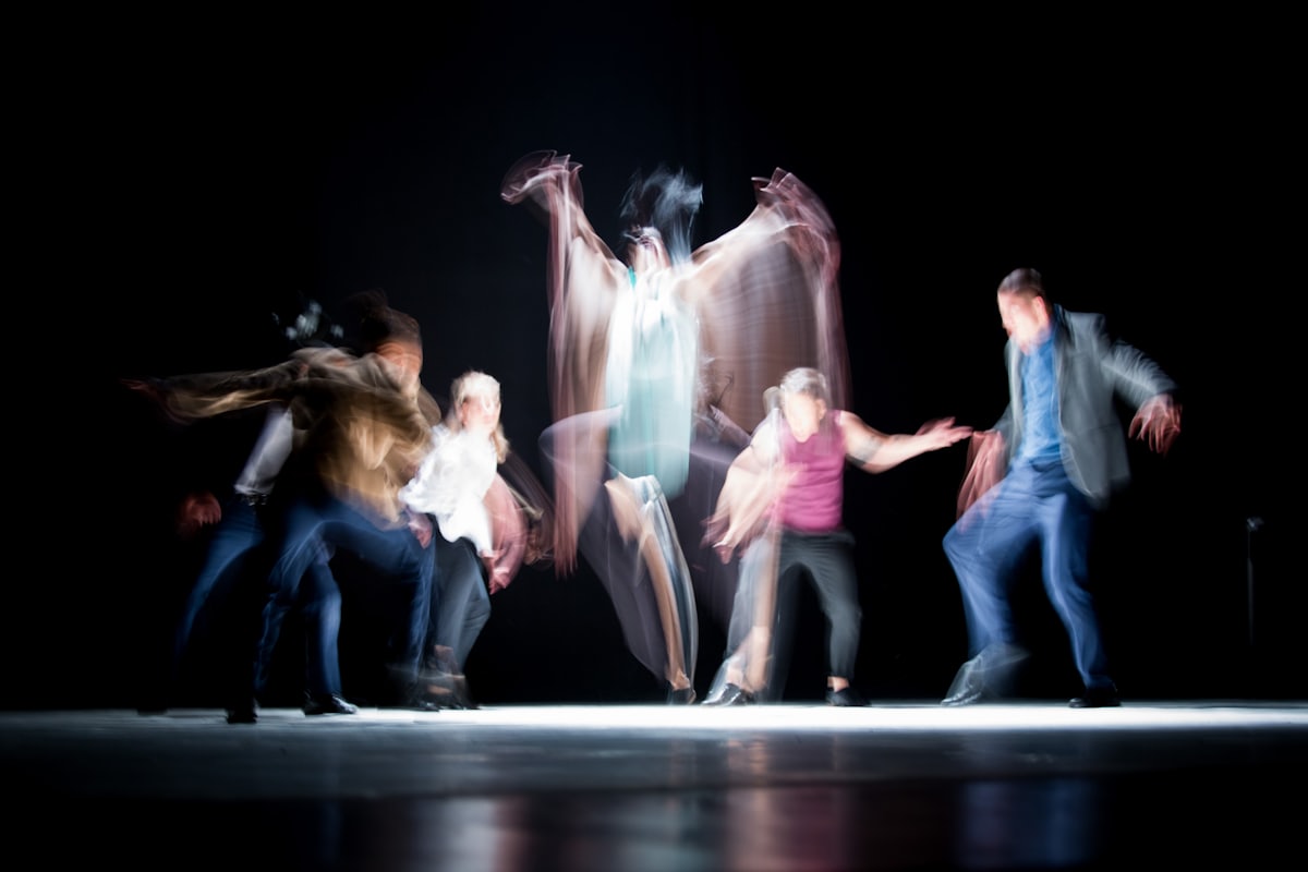 A blurred figure turning through a field of blue light