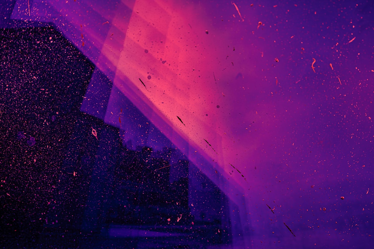 Fine particles suspended in a shaft of colored light