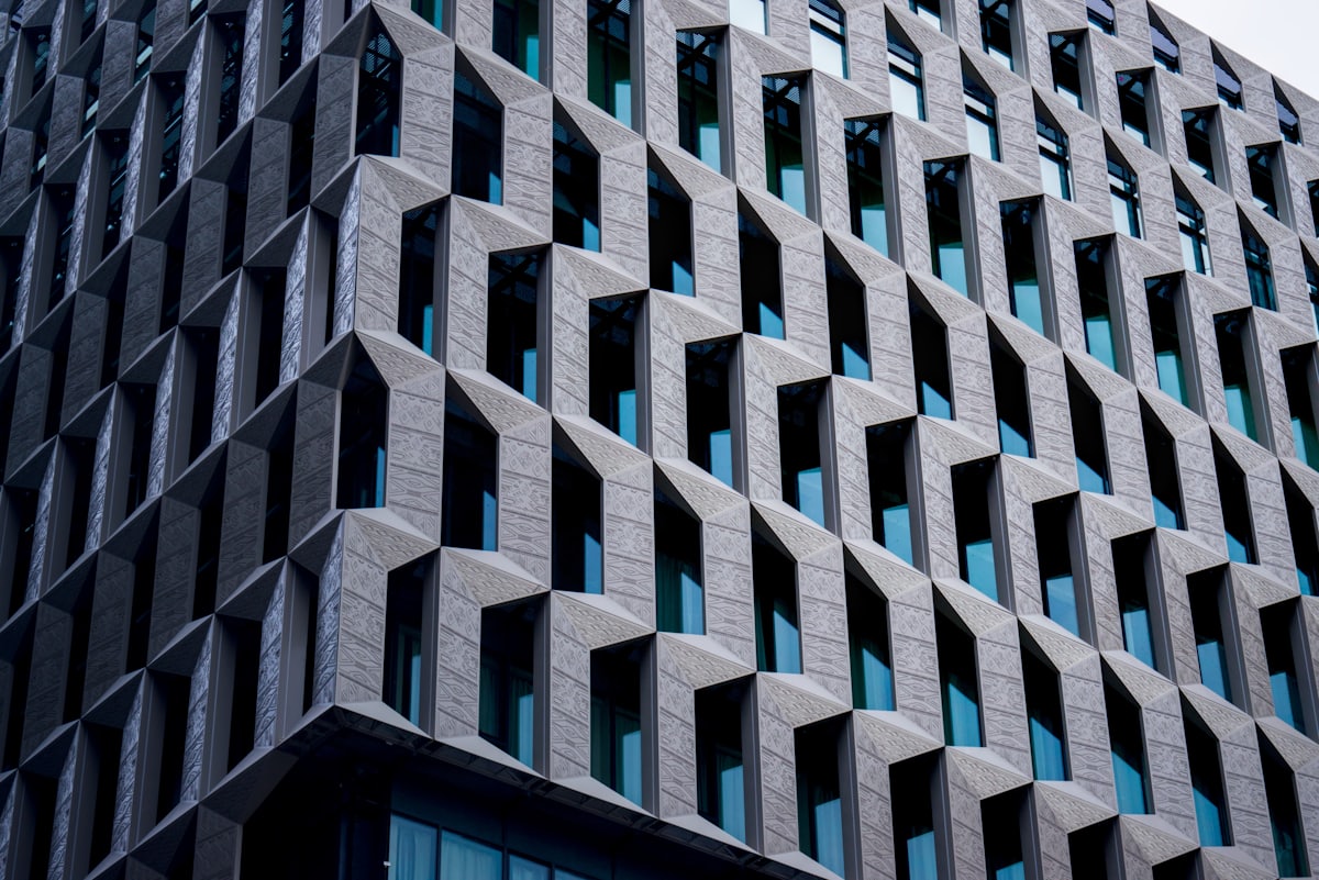 Blue glazed facade set within a measured concrete grid